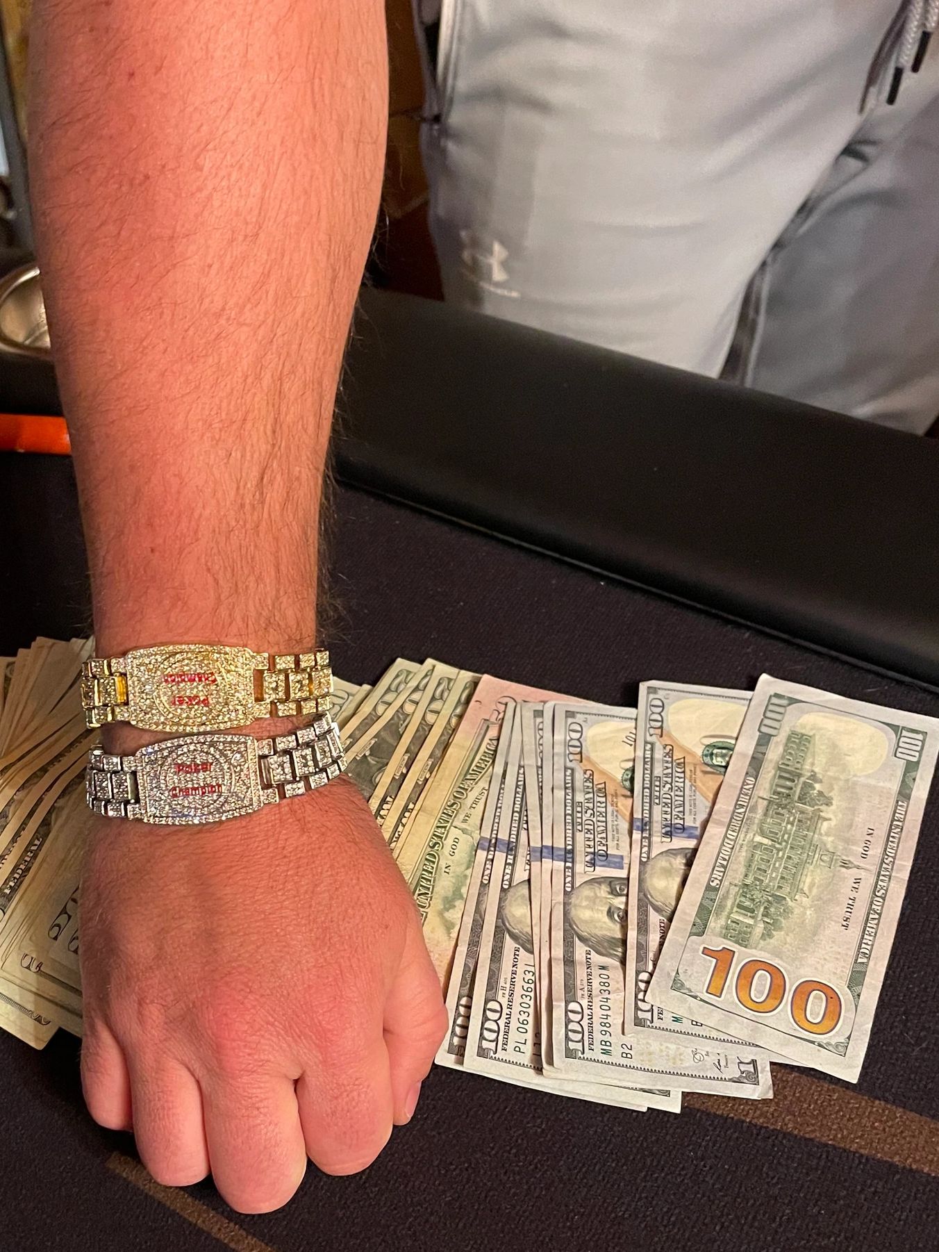 Winner showing off the bracelet and cash